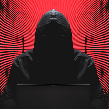 Ransomware report graphic: cyber criminal at a computer terminal