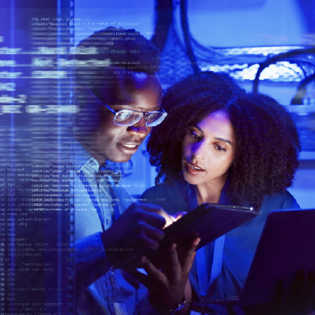 A man and woman look at a tablet screen as computer text scrolls in view.